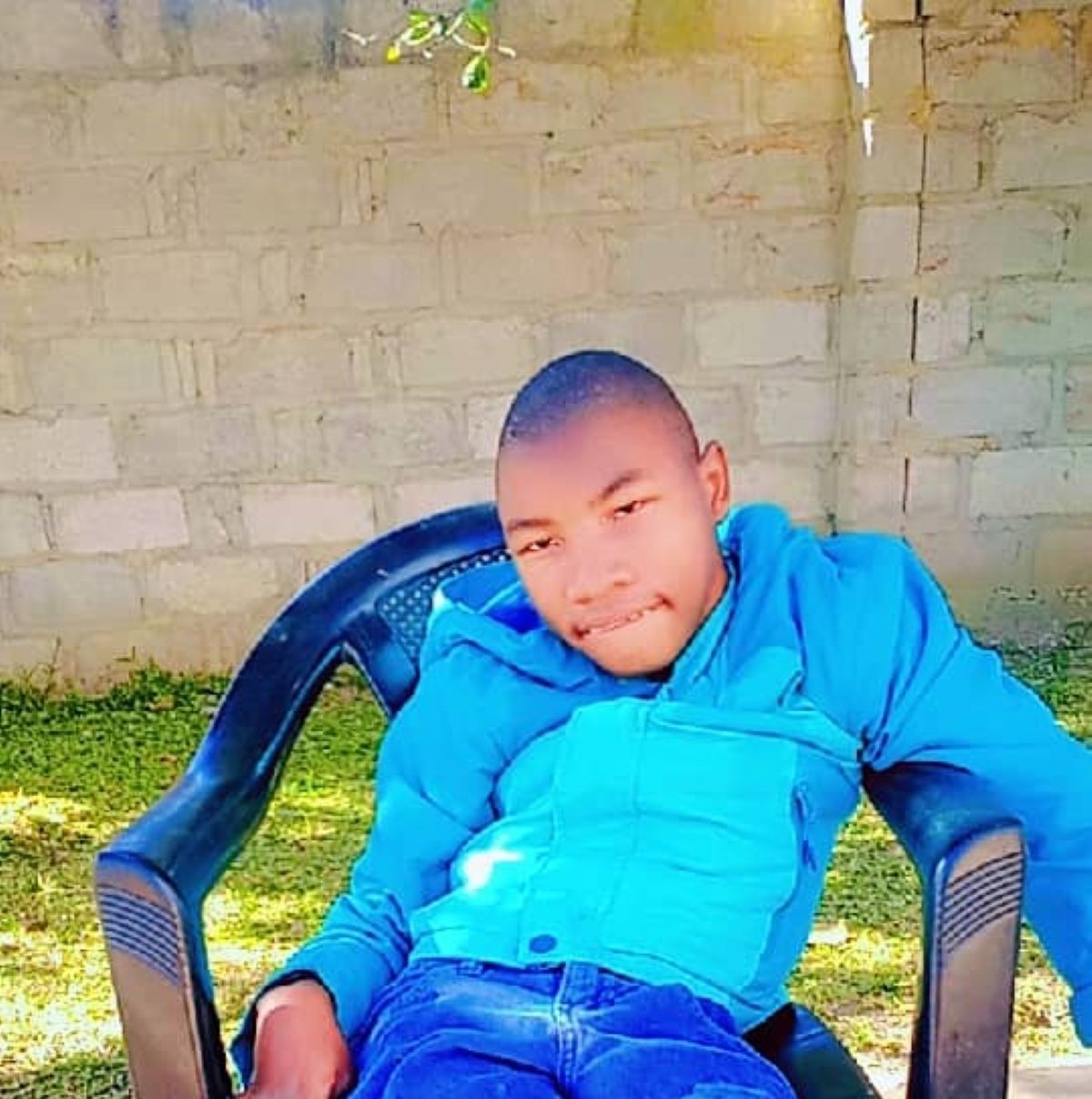 Federic, an 18-year-old who cannot walk and has limited speech, receiving support